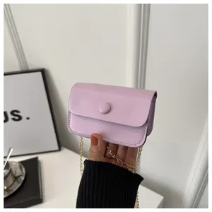 Detail of light purple mini chain bag featuring a smooth PU texture and round buckle