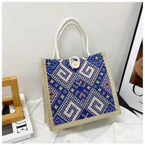 Detail of blue and white ethnic geometric pattern on the canvas tote with rope handle
