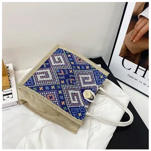 Detailed close-up of woven geometric pattern and rope handle on ethnic canvas tote bag