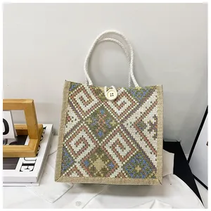 Detailed close-up of ethnic woven tote bag with geometric patterns and rope handles