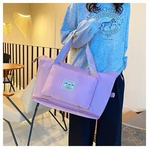 Close-up of lightweight lavender nylon travel bag with brand tag and zipper pocket