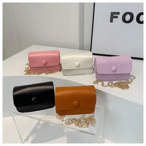 Detailed view of five mini chain crossbody bags in assorted colors and fine leather texture
