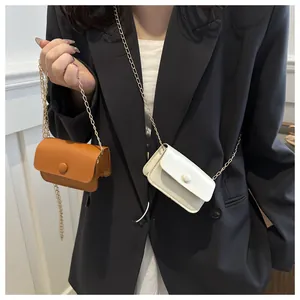 Mini leather shoulder bags in caramel and cream colors with delicate gold chain straps