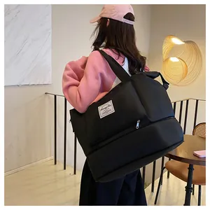 Detail of black foldable travel bag with waterproof nylon texture and bottom expansion