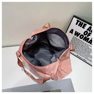 Pink travel bag detail showing large main compartment and inner zipper pocket storage