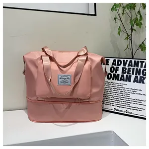 Detailed view of pink foldable travel bag featuring independent bottom shoe compartment