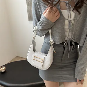 White faux-croc crescent shoulder bag with rope handle and gold buckle detail