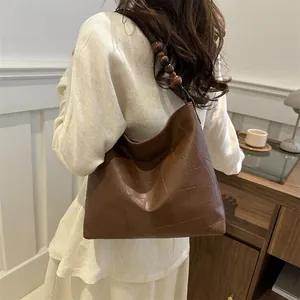Brown PU leather tote bag with geometric texture and wooden bead shoulder strap detail