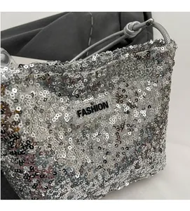 Close-up of shiny silver sequins and Fashion logo on a large capacity tote bag