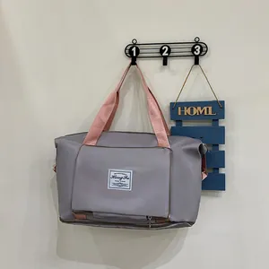 Large folding travel bag in dark grey and pink with waterproof fabric for gym and sports