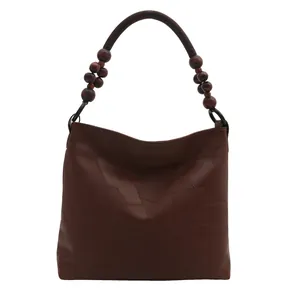 Dark brown leather hobo shoulder bag with patchwork design and wooden bead strap