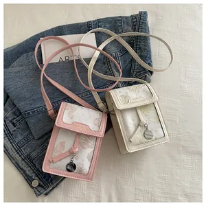 Detail view of pink and beige mini floral crossbody phone bags with star pattern