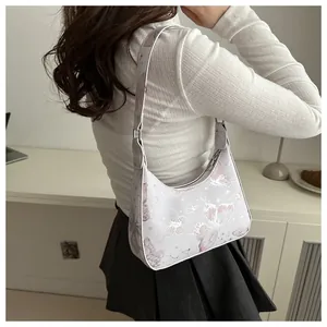 Detail of light purple hobo bag with butterfly print and constellation patterns