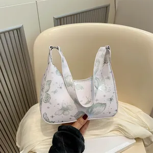 White minimalist butterfly print hobo bag with sleek top handle and metallic zipper