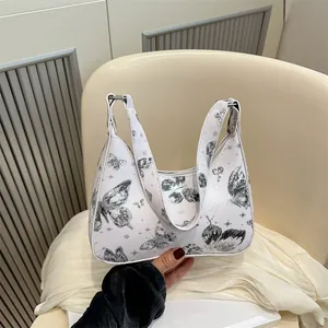 White butterfly print hobo bag with a minimalist bow design and a smooth PU leather finish