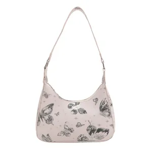 Pink hobo shoulder bag with black butterfly print and star patterns on white background