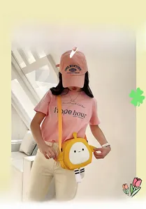 Close-up of yellow egg-shaped cartoon canvas crossbody bag with cute dangling striped legs
