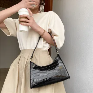 Chic black crocodile pattern crescent shoulder bag for women with golden metal buckle