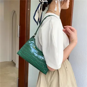 Chic dark green crocodile embossed baguette bag with sleek shoulder strap for women