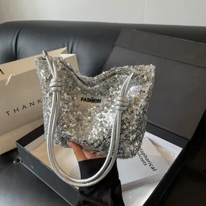 Silver sequin tote bag with dual shoulder straps and fashion label in a luxury gift box