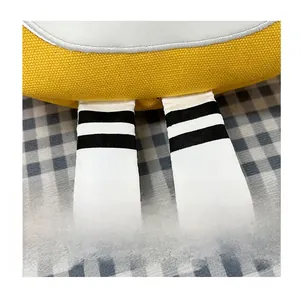 Detail of yellow canvas bag featuring cute striped leg-like ribbons and white trim