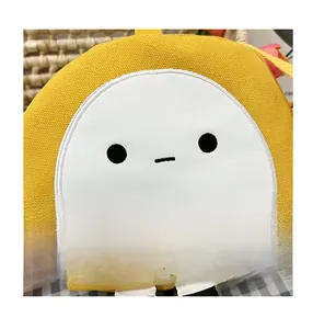Detail of cute yellow round canvas bag with cartoon face and striped legs decor