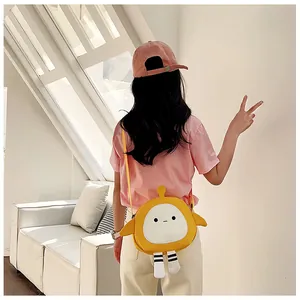 Rear view of model wearing a cute yellow cartoon crossbody bag with small wings and legs