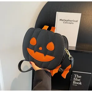 Detail of black pumpkin bag with orange facial patches and textured faux leather finish