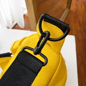 Detalle del gancho giratorio negro de calidad y anilla en D en bolso de lona amarillo