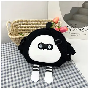 Detail of cute black canvas crossbody bag with cartoon face and 3D legs decoration