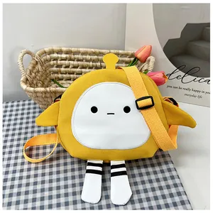 Detail of cute yellow cartoon canvas crossbody bag with 3D wings and striped legs decoration