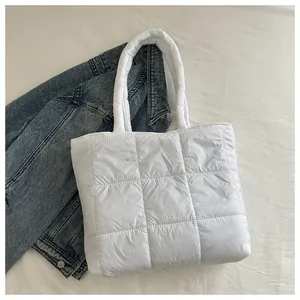 Close-up of a white quilted puffer tote bag with a soft texture and spacious design