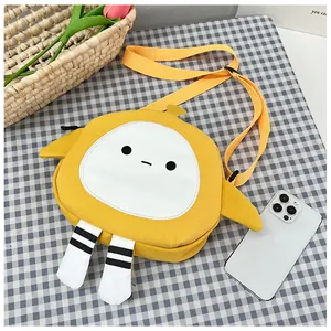 Detail view of yellow canvas cartoon crossbody bag with adjustable nylon shoulder strap