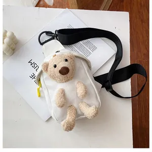 White canvas crossbody chest bag featuring 3D plush brown teddy bear and wide black strap