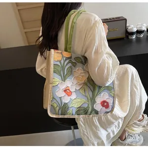 Gros plan de la broderie florale sur un grand sac cabas au style rétro chic