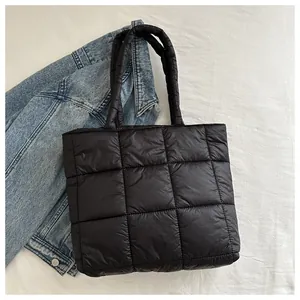 Detail of black quilted tote bag texture with plush padded cotton and grid stitching