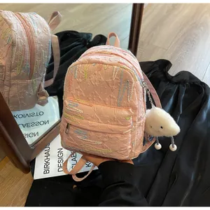 Detailed embroidery and diamond texture on mini pink backpack with cloud pendant