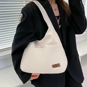 Minimalist beige tote bag in soft matte leather with brown square fashion patch detail