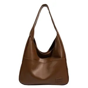 Minimalist vintage dark brown PU leather tote bag with a spacious front pocket and strap