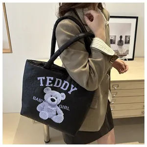 Close-up of quilted black nylon tote bag featuring cute purple teddy bear print