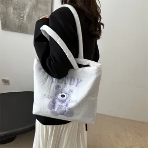 Quilted white tote bag featuring a cute purple teddy bear print with baby girl text