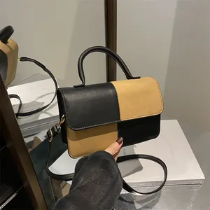 Checkerboard crossbody square bag in black and khaki faux leather with top handle