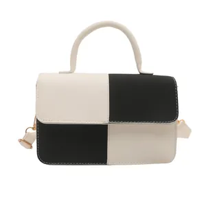 Checkerboard pattern crossbody bag with contrast stitching and handle on white background