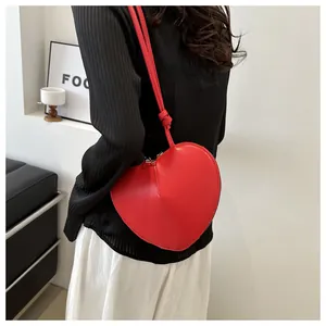 Detailansicht einer leuchtend roten herzförmigen Ledertasche mit glatter PU-Oberfläche