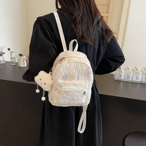 Minimalist white quilted small backpack with colorful embroidery and plush cloud charm