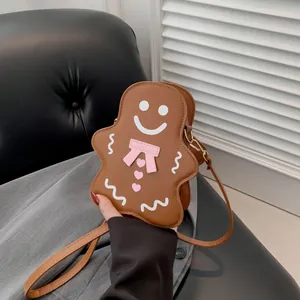Sac bandoulière bonhomme de pain d'épices en cuir marron avec visage mignon et nœud rose