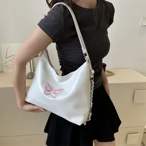 White hobo shoulder bag with pink embroidered butterfly and stylish silver chain detail