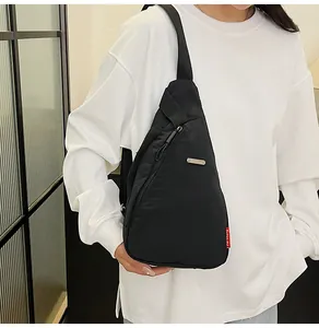 Side view of a black nylon crossbody chest bag on model showcasing size and fit