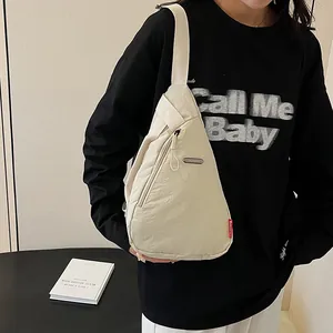 Minimalist beige triangular nylon chest bag with adjustable strap for men and women