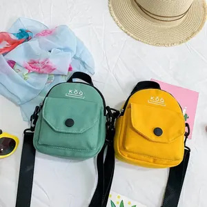 Minimalist canvas crossbody bags in green and yellow with summer travel accessories